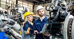 Automotive workers inspecting automotive parts in a factory